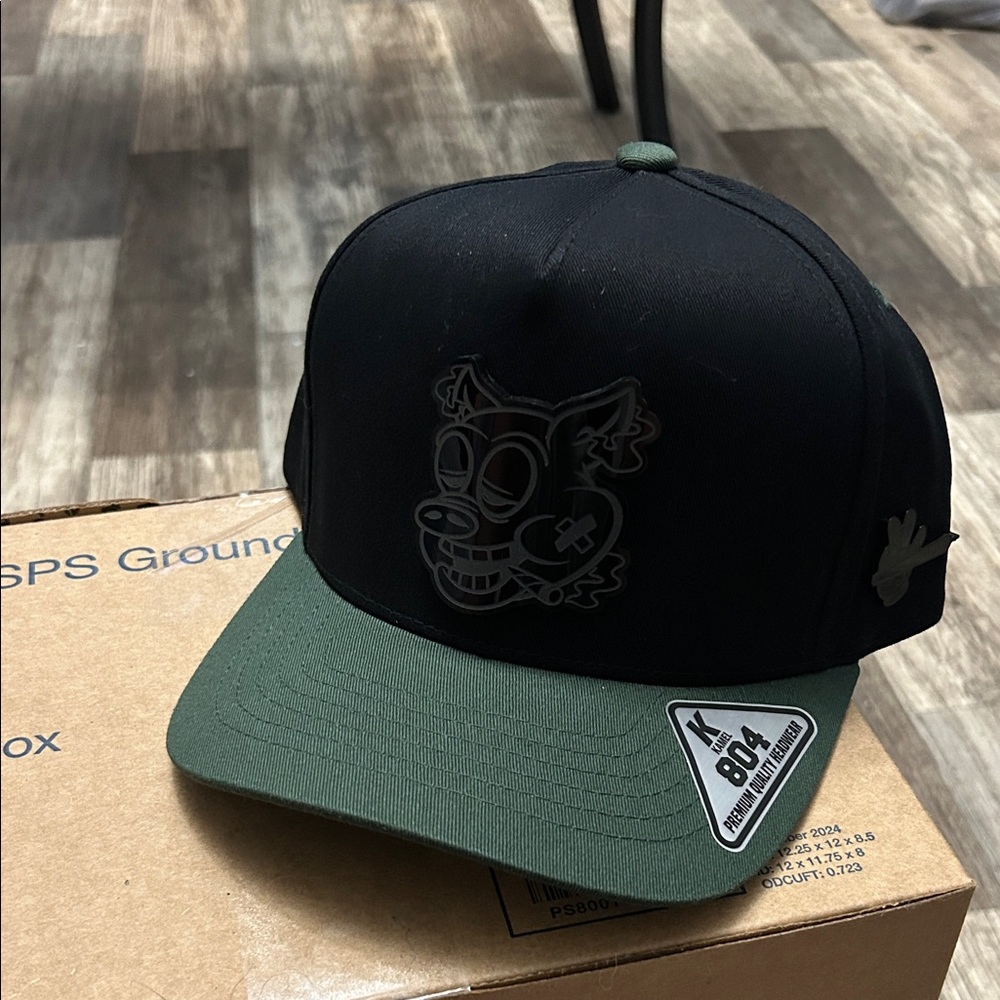 Black and Green Cap with Cartoon Design
